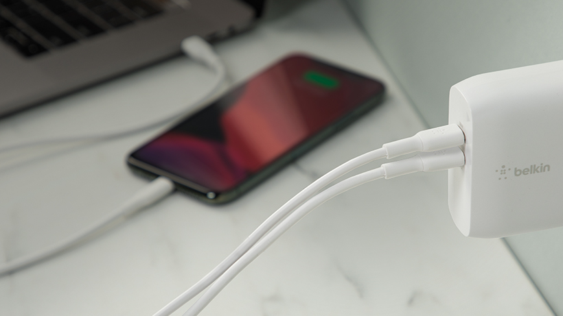 Next-level charging with advanced GaN technology Laptop and phone being charged with the BOOST↑CHARGE Dual USB-C GaN Wall Charger 68W